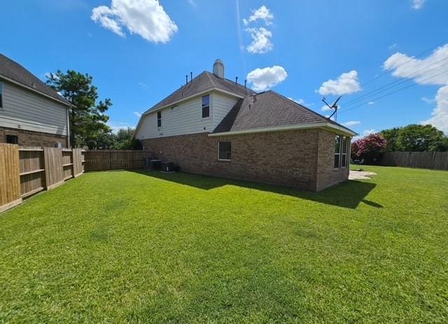 2547 Crystal Shore Dr, Rosharon, TX 77583 - rear view of property with brick siding and a fenced backyard