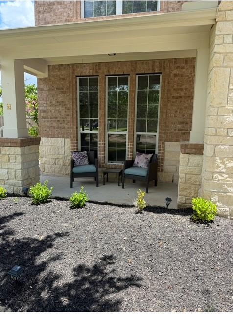 2547 Crystal Shore Dr, Rosharon, TX 77583 - view of exterior entry with a porch and brick siding