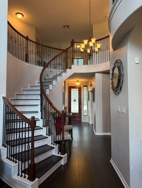 2547 Crystal Shore Dr, Rosharon, TX 77583 - foyer with a chandelier, stairs, a towering ceiling, and dark wood-type flooring