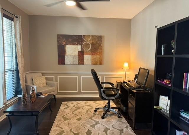2547 Crystal Shore Dr, Rosharon, TX 77583 - office featuring ceiling fan, wood finished floors, and a wainscoted wall
