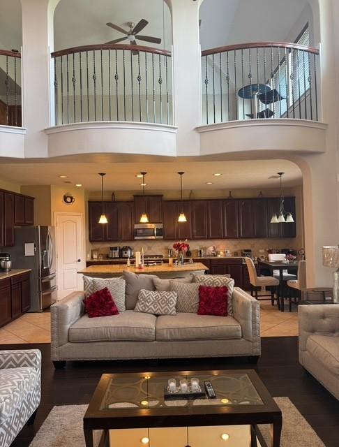 2547 Crystal Shore Dr, Rosharon, TX 77583 - living area with a towering ceiling, ceiling fan, and light wood-style flooring