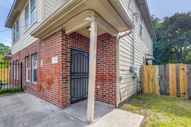 8126 Jutland Rd, Houston, TX 77033 - property entrance featuring brick siding and a gate