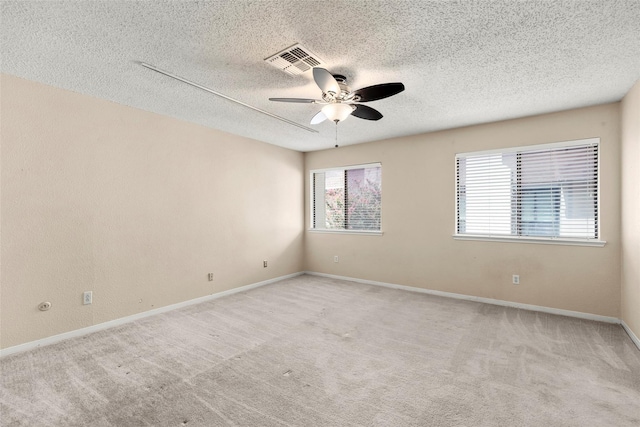 1112 Bering Dr Unit 47, Houston, TX 77057 - spare room featuring a ceiling fan, a textured ceiling, and light colored carpet