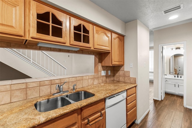 1112 Bering Dr Unit 47, Houston, TX 77057 - kitchen featuring white dishwasher, glass insert cabinets, decorative backsplash, wood finished floors, and a textured ceiling