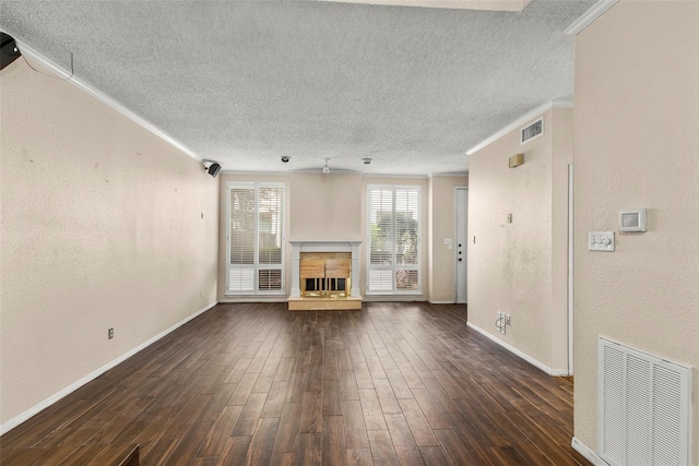 1112 Bering Dr Unit 47, Houston, TX 77057 - unfurnished living room with a textured ceiling, crown molding, dark wood-style flooring, a fireplace with raised hearth, and a textured wall