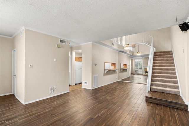 1112 Bering Dr Unit 47, Houston, TX 77057 - unfurnished living room with dark wood finished floors, crown molding, ceiling fan, a textured ceiling, and stairway