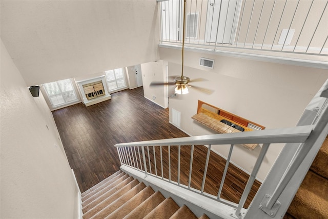 1112 Bering Dr Unit 47, Houston, TX 77057 - stairway featuring a high ceiling, ceiling fan, and wood finished floors