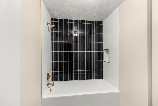 1112 Bering Dr Unit 47, Houston, TX 77057 - bathroom view of  shower combination and a textured ceiling