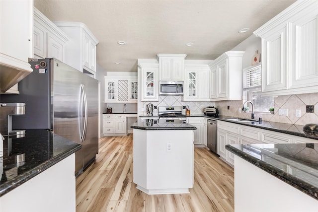 1018 N Commons View Dr, Houston, TX 77336 - kitchen with appliances with stainless steel finishes, light wood-type flooring, dark stone counters, and recessed lighting