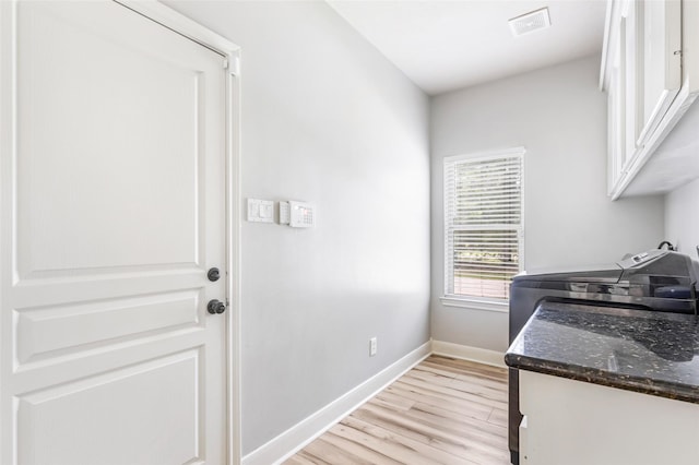 1018 N Commons View Dr, Houston, TX 77336 - laundry area featuring cabinet space, light wood-style floors, and independent washer and dryer