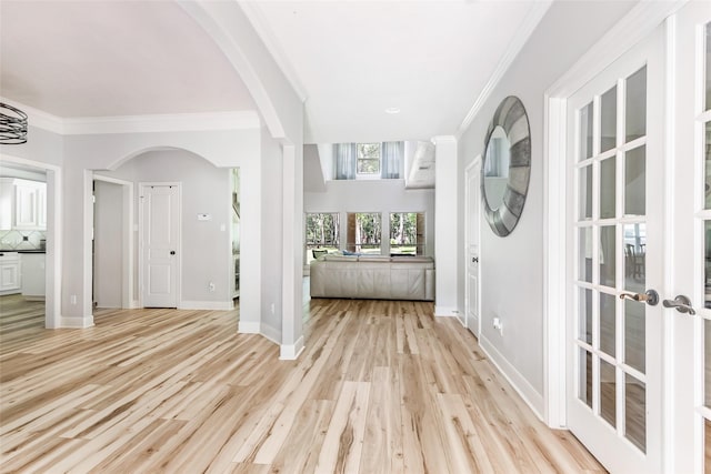 1018 N Commons View Dr, Houston, TX 77336 - entrance foyer featuring arched walkways, ornamental molding, light wood-style flooring, and french doors