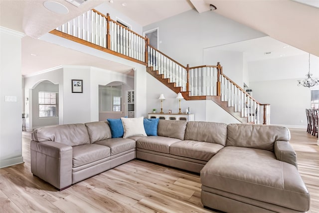 1018 N Commons View Dr, Houston, TX 77336 - living room featuring high vaulted ceiling, wood finished floors, stairway, arched walkways, and a chandelier