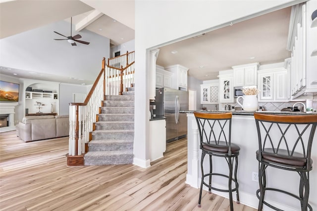 1018 N Commons View Dr, Houston, TX 77336 - kitchen featuring appliances with stainless steel finishes, a peninsula, a ceiling fan, backsplash, and open floor plan