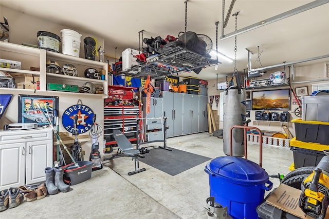 1018 N Commons View Dr, Houston, TX 77336 - garage featuring a garage door opener and a workshop area