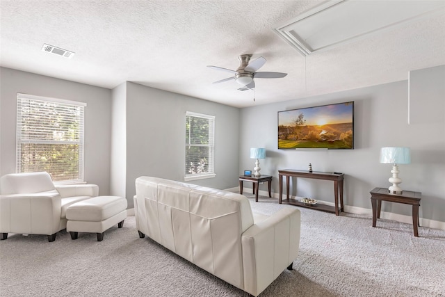 1018 N Commons View Dr, Houston, TX 77336 - living room with light colored carpet, a textured ceiling, a ceiling fan, and attic access
