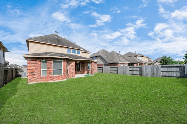 9119 Basin Ridge Ln, Richmond, TX 77407 - back of property featuring brick siding, a fenced backyard, a patio area, a shingled roof, and a residential view