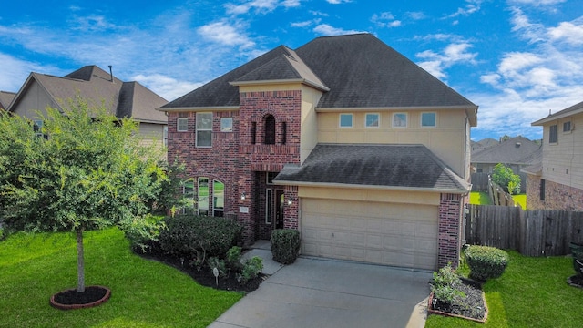 9119 Basin Ridge Ln, Richmond, TX 77407 - traditional home with brick siding, concrete driveway, stucco siding, roof with shingles, and an attached garage
