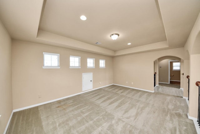 9119 Basin Ridge Ln, Richmond, TX 77407 - empty room featuring a raised ceiling, arched walkways, light carpet, healthy amount of natural light, and recessed lighting