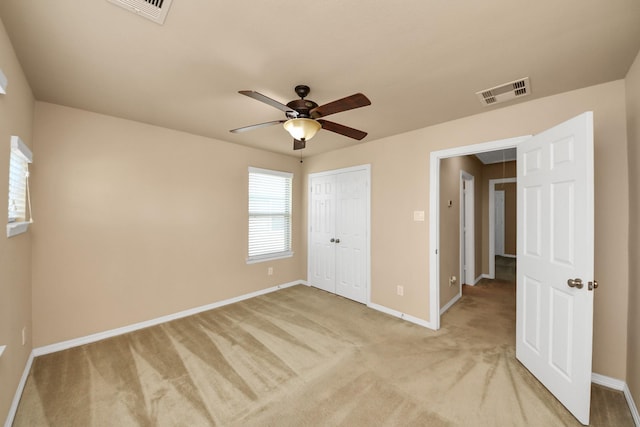 9119 Basin Ridge Ln, Richmond, TX 77407 - unfurnished bedroom featuring light carpet, a closet, and ceiling fan