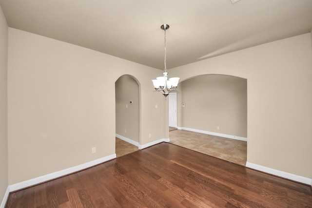 9119 Basin Ridge Ln, Richmond, TX 77407 - unfurnished room featuring arched walkways, a chandelier, and wood finished floors