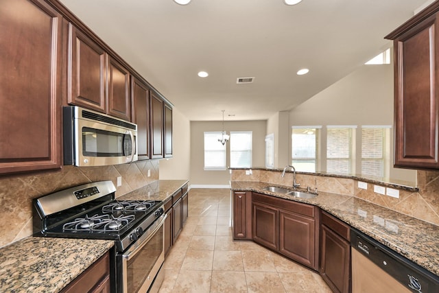 9119 Basin Ridge Ln, Richmond, TX 77407 - kitchen with stainless steel appliances, stone countertops, tasteful backsplash, and recessed lighting