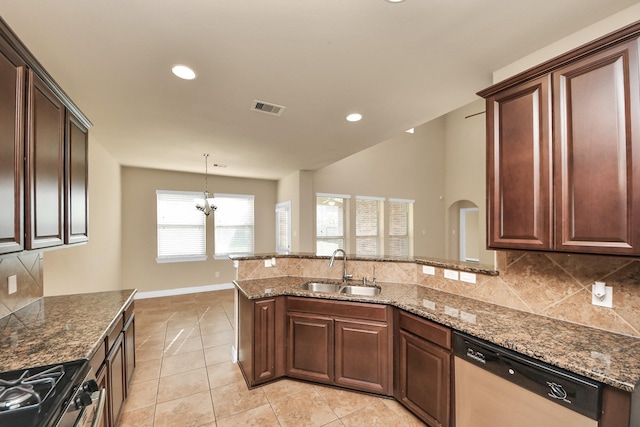 9119 Basin Ridge Ln, Richmond, TX 77407 - kitchen with stainless steel appliances, a peninsula, tasteful backsplash, light tile patterned floors, and dark stone countertops