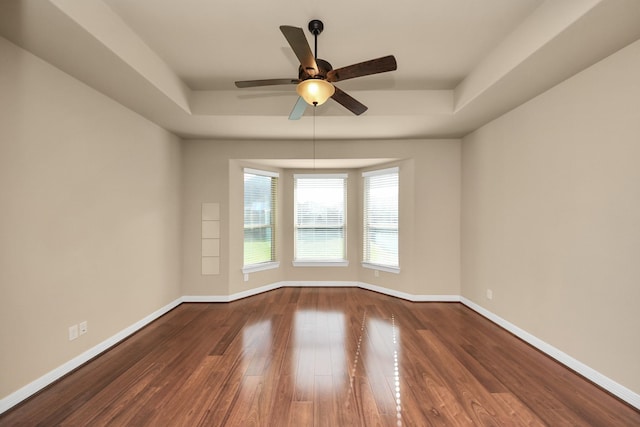 9119 Basin Ridge Ln, Richmond, TX 77407 - empty room featuring a tray ceiling, wood finished floors, and ceiling fan