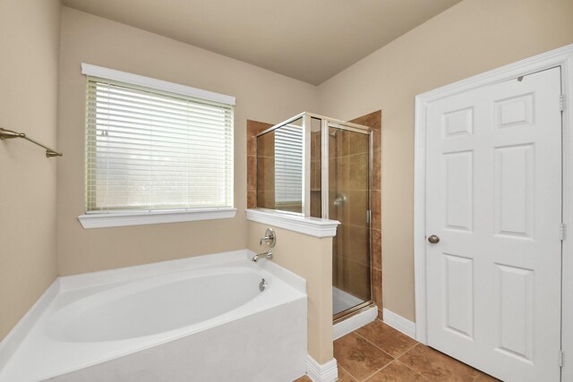 9119 Basin Ridge Ln, Richmond, TX 77407 - bathroom with a bath, a shower stall, and tile patterned floors