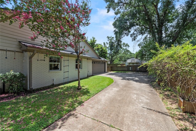 5617 Valerie St, Houston, TX 77081 - view of front of home featuring driveway, brick siding, and an attached garage