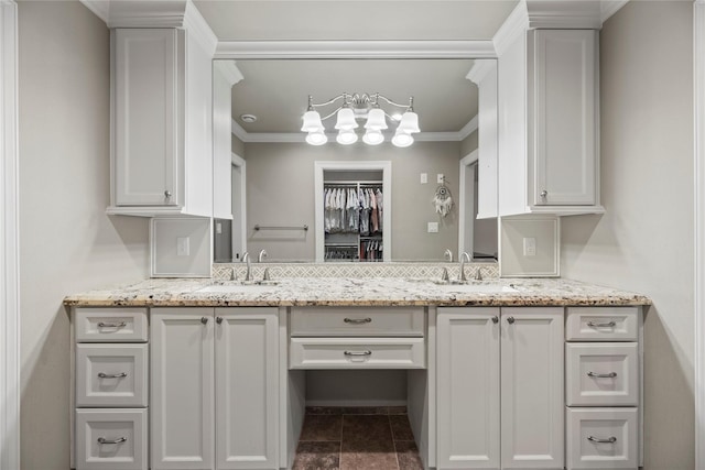 5617 Valerie St, Houston, TX 77081 - kitchen with ornamental molding, white cabinets, and light stone countertops