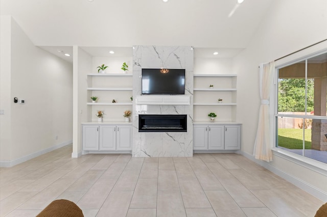 532 Carrell St, Tomball, TX 77375 - unfurnished living room with built in shelves, a high end fireplace, recessed lighting, and vaulted ceiling