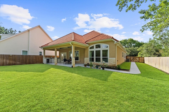 532 Carrell St, Tomball, TX 77375 - rear view of house featuring a fenced backyard, a patio area, stone siding, stucco siding, and ceiling fan