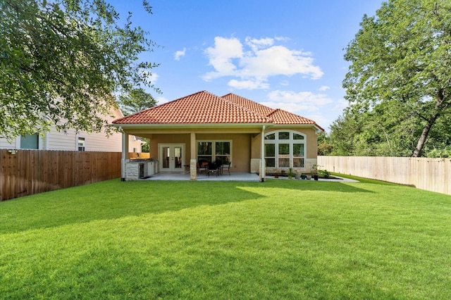 532 Carrell St, Tomball, TX 77375 - back of house with french doors, a fenced backyard, a patio area, a tile roof, and stucco siding