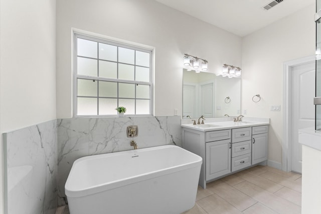 532 Carrell St, Tomball, TX 77375 - bathroom with a soaking tub, double vanity, and tile patterned floors