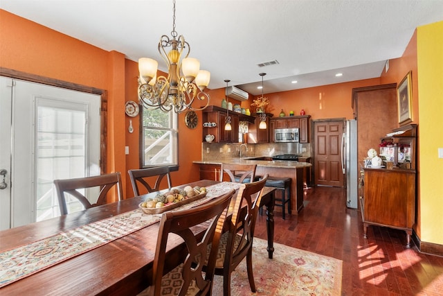 1820 Winnie St, Galveston, TX 77550 - dining space with dark wood-style flooring, a chandelier, an AC wall unit, and recessed lighting