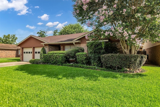 16622 Ben Nevis Dr, Houston, TX 77084 - view of front of property featuring an attached garage, brick siding, a front lawn, driveway, and roof with shingles