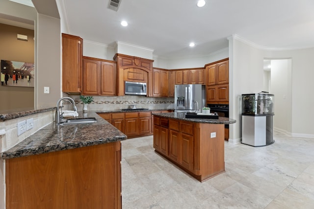 13506 Key Ridge Ln, Cypress, TX 77429 - kitchen with appliances with stainless steel finishes, dark stone counters, decorative backsplash, an island with sink, and brown cabinets