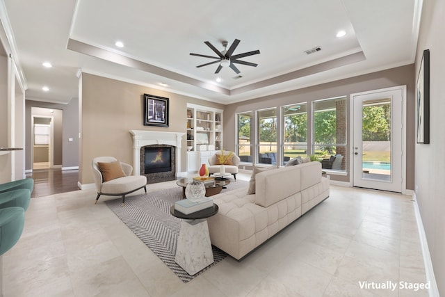13506 Key Ridge Ln, Cypress, TX 77429 - living area with a tray ceiling, a high end fireplace, a ceiling fan, ornamental molding, and recessed lighting