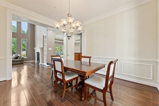 13506 Key Ridge Ln, Cypress, TX 77429 - dining room with a chandelier, crown molding, dark wood finished floors, wainscoting, and a fireplace