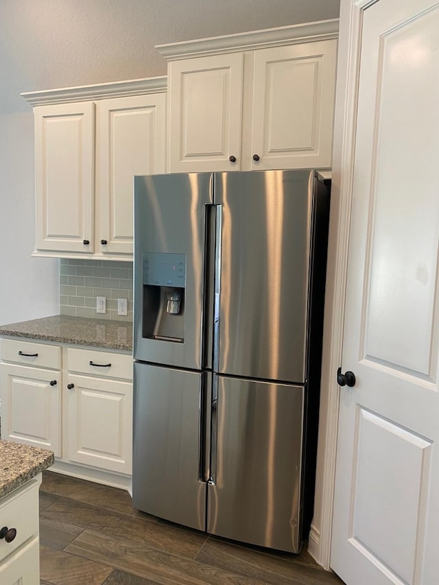 19002 Dublin Bay Blvd, Tomball, TX 77377 - kitchen featuring stainless steel fridge, light stone counters, white cabinetry, tasteful backsplash, and dark wood finished floors