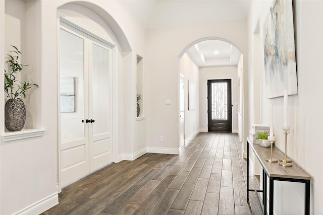 19002 Dublin Bay Blvd, Tomball, TX 77377 - entrance foyer featuring arched walkways, dark wood-style floors, a tray ceiling, and recessed lighting