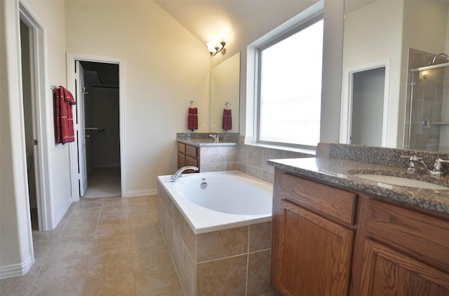 12421 Berberry Dr, Texas City, TX 77568 - bathroom featuring two vanities, a bath, a shower stall, lofted ceiling, and tile patterned flooring