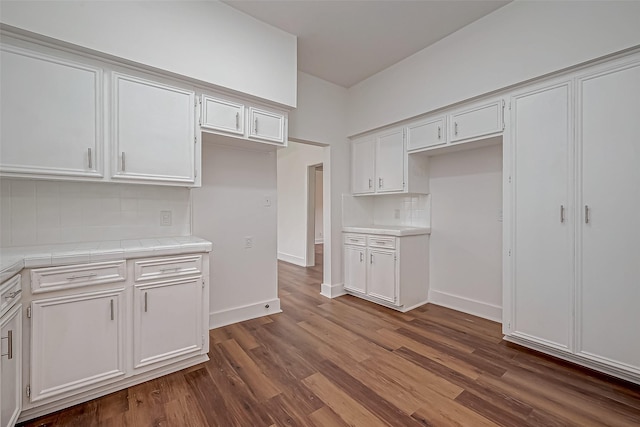 3280 Berry St, Houston, TX 77004 - kitchen with tile countertops, decorative backsplash, white cabinetry, and dark wood-type flooring