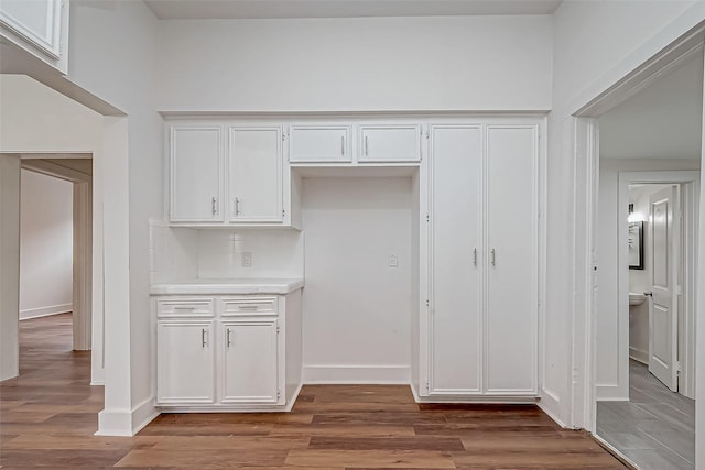 3280 Berry St, Houston, TX 77004 - kitchen with white cabinets, wood finished floors, and light countertops