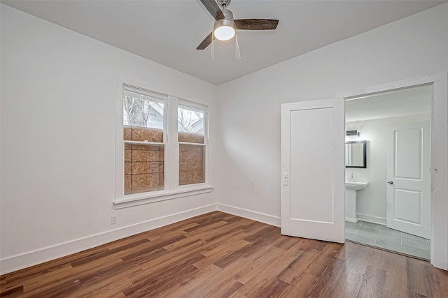 3280 Berry St, Houston, TX 77004 - unfurnished bedroom featuring wood finished floors, connected bathroom, and a ceiling fan