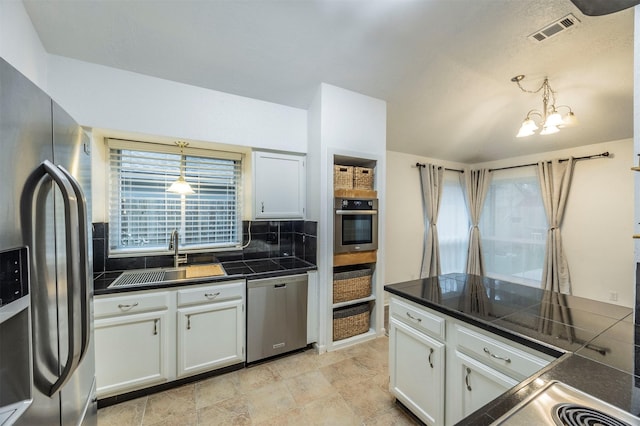 8526 Greenleaf Lake Dr, Houston, TX 77095 - kitchen featuring appliances with stainless steel finishes, tasteful backsplash, and white cabinetry