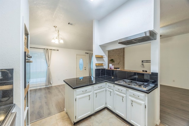 8526 Greenleaf Lake Dr, Houston, TX 77095 - kitchen featuring stainless steel appliances, extractor fan, white cabinetry, a peninsula, and a chandelier