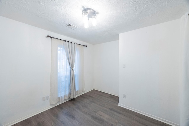 8526 Greenleaf Lake Dr, Houston, TX 77095 - empty room with dark wood-style floors and a textured ceiling