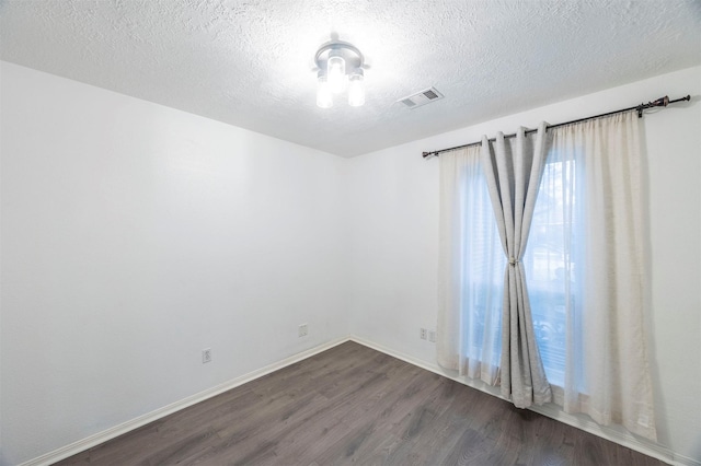 8526 Greenleaf Lake Dr, Houston, TX 77095 - empty room with dark wood-type flooring and a textured ceiling