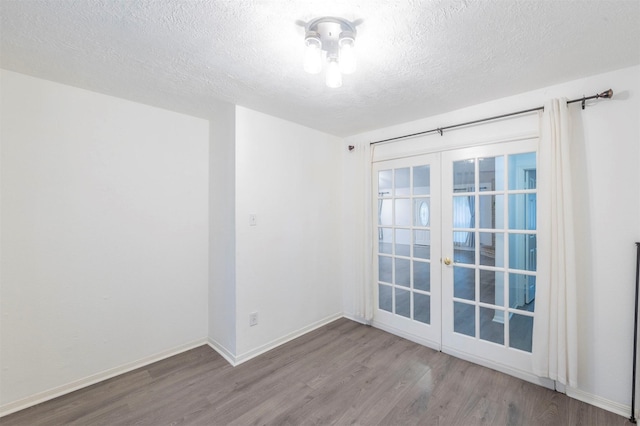 8526 Greenleaf Lake Dr, Houston, TX 77095 - unfurnished room featuring wood finished floors, french doors, and a textured ceiling